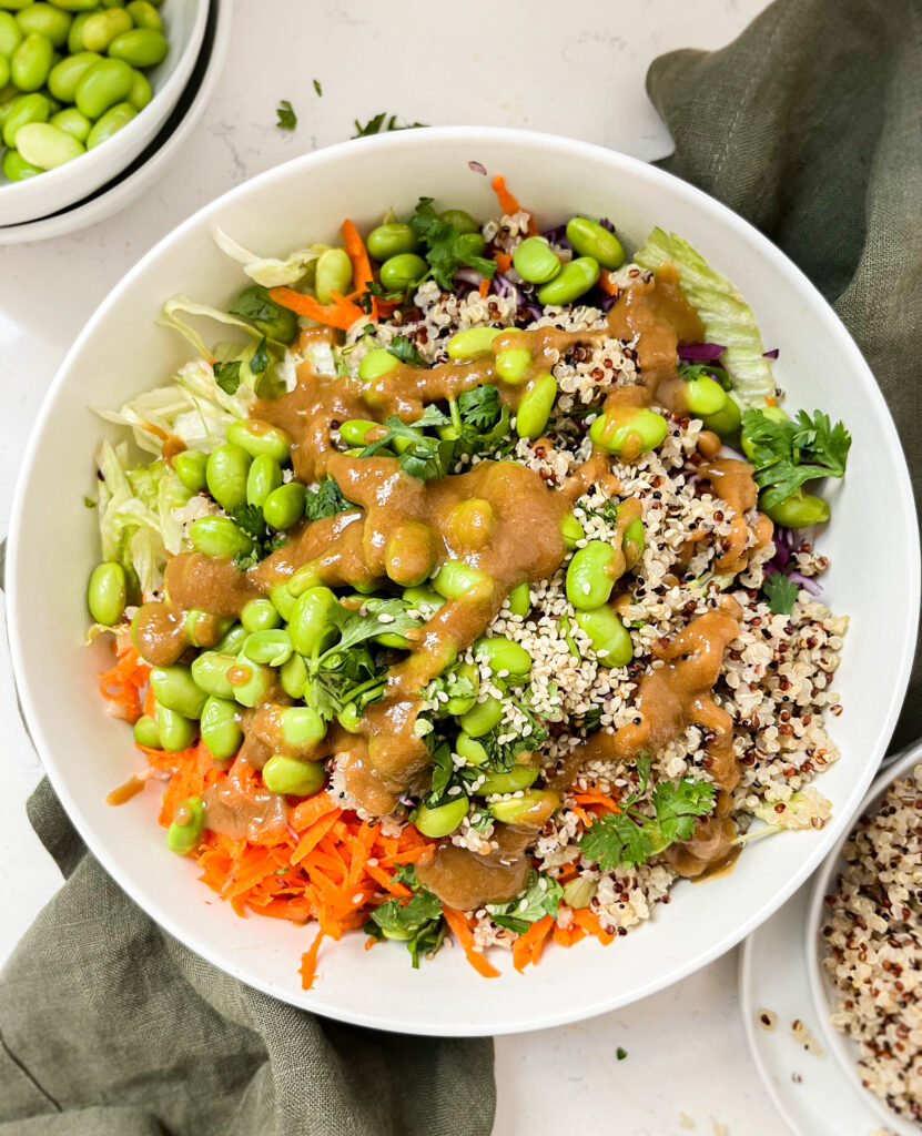 bowl of crunchy thai peanut salad on a green linen cloth