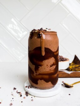 a glass of dark chocolate smoothie with chocolate swirls