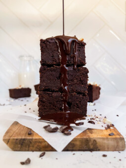 sweet potato brownies with chocolate ganache poured on top on a cutting board