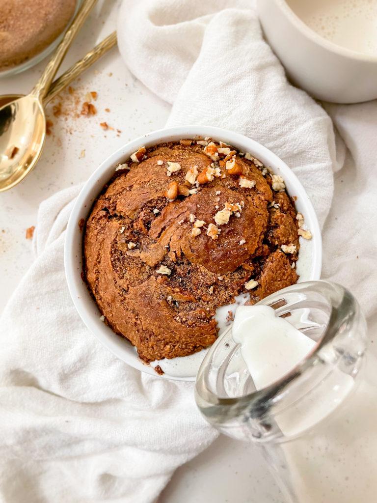 cinnamon roll baked oats in a ramekin on a linen