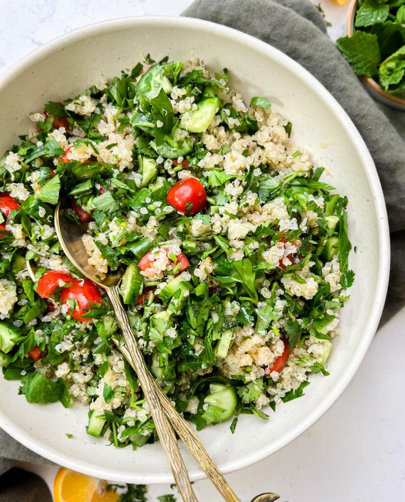 tabbouleh salad in a white bowl on a green linen cloth