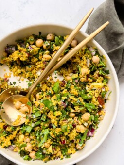 bowl of golden moroccan quinoa salad on a green linen cloth