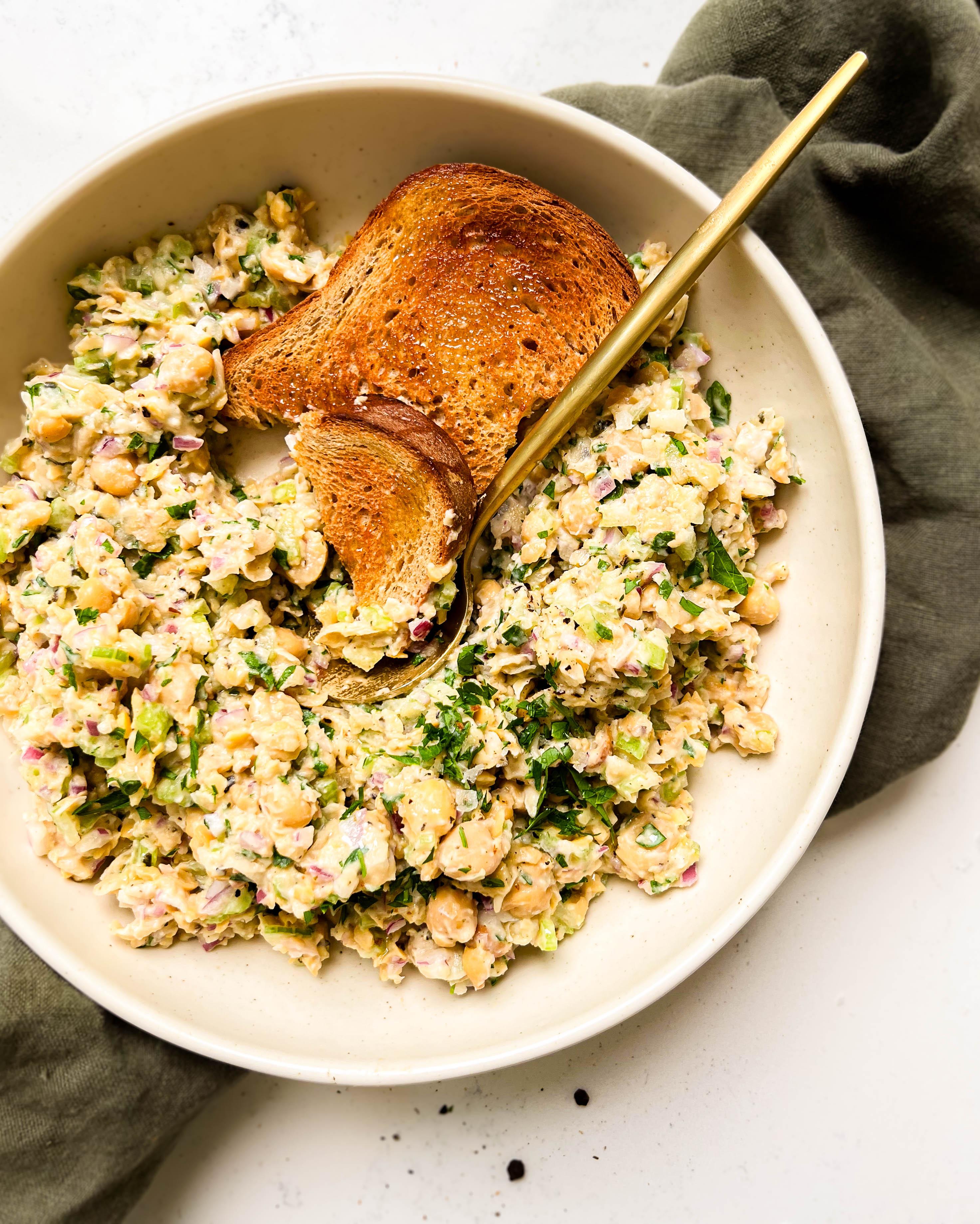 bowl of chickpea tuna salad on a green cloth