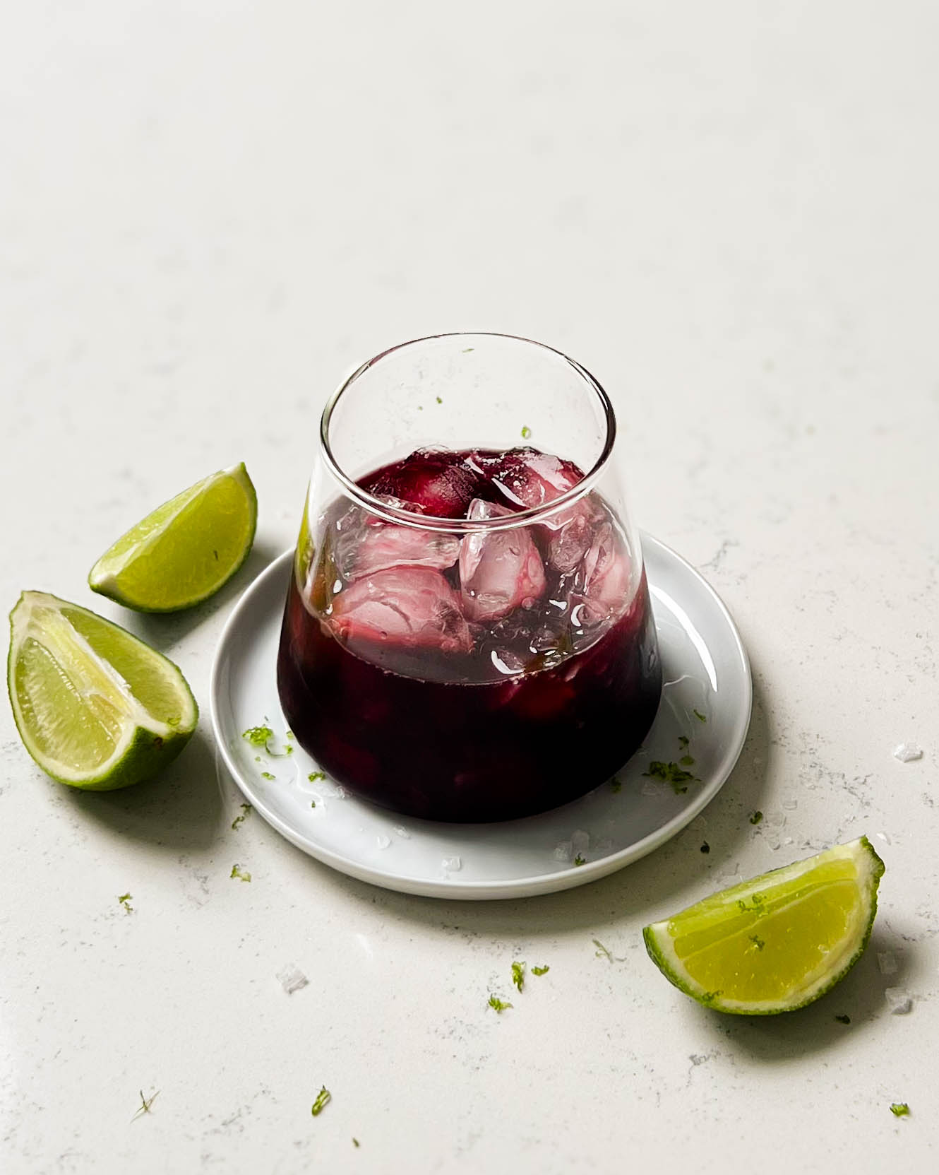 glass of TikTok tart cherry mocktail with lime wedges