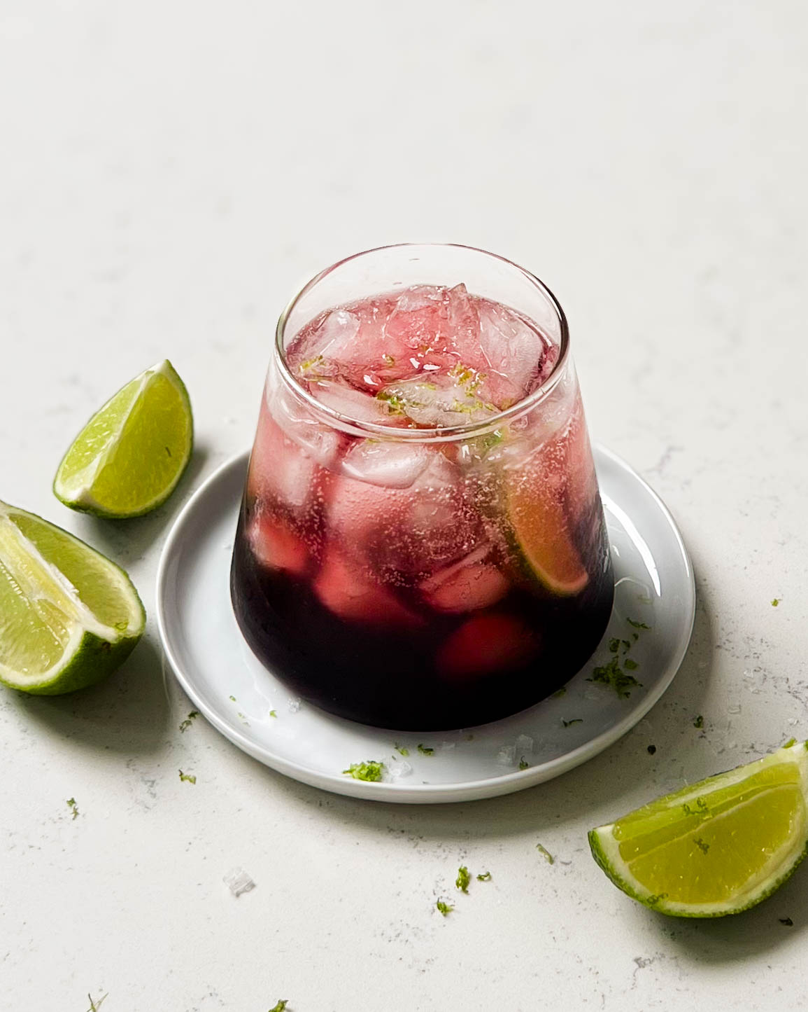 glass of TikTok tart cherry mocktail with lime wedges