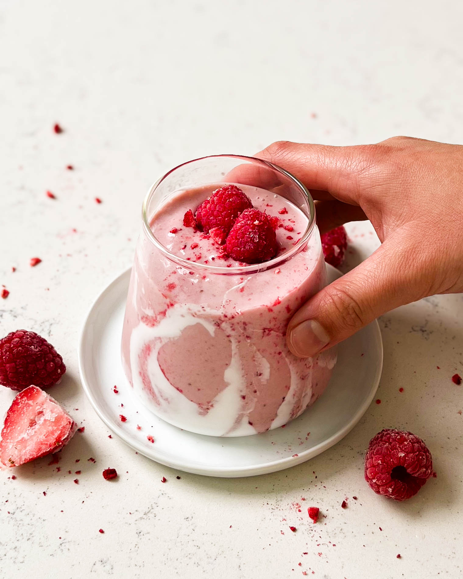 strawberry coconut cloud smoothie in a triangle glass