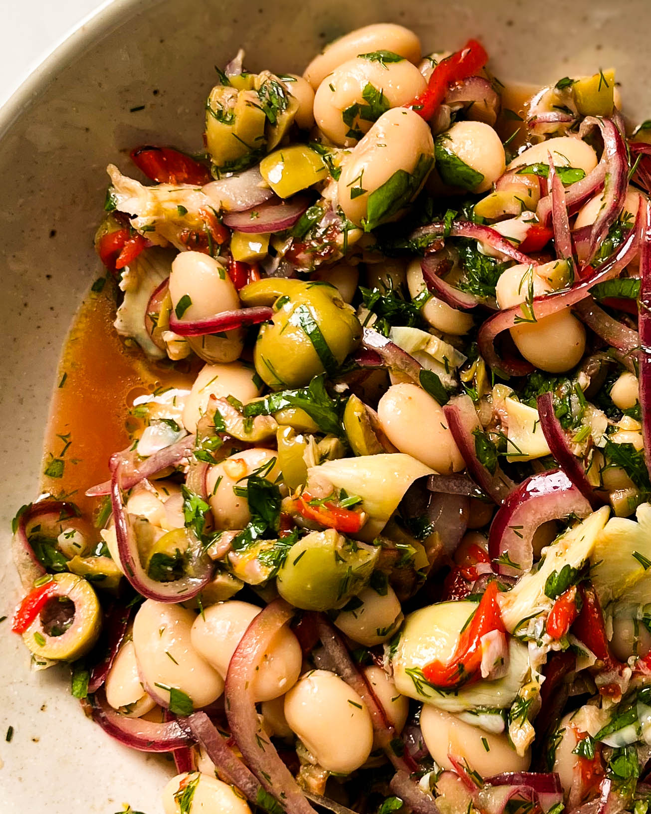 marinated butter beans in a white bowl