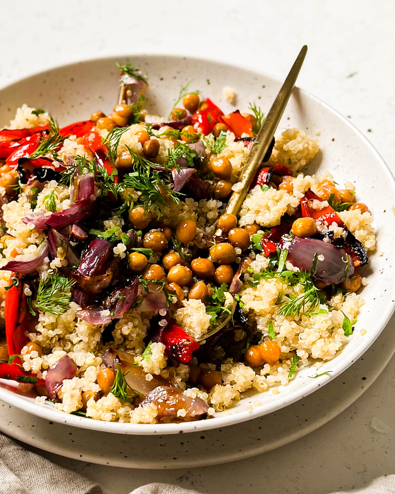 roasted red pepper salad in a white bowl