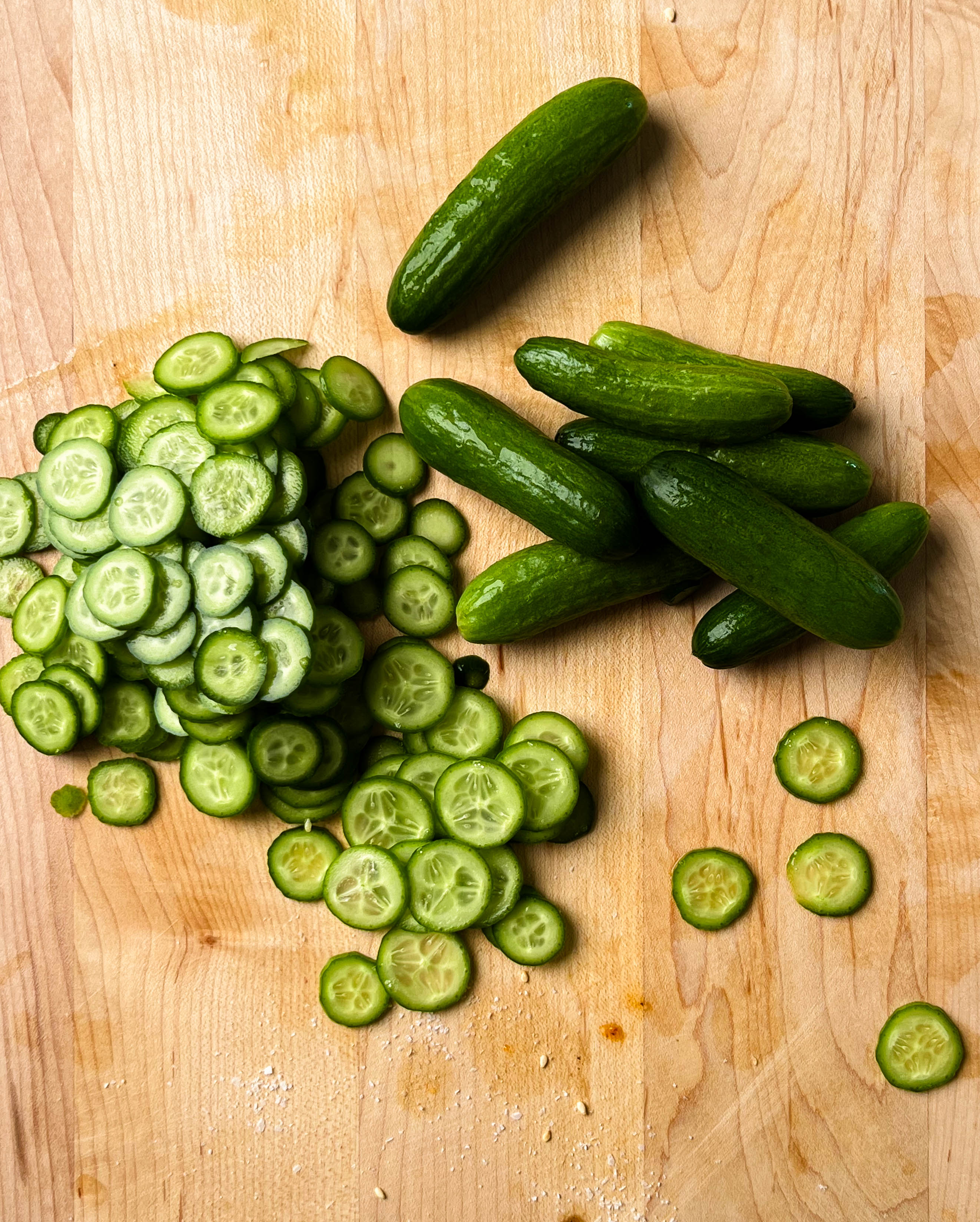 thinly sliced cucumber on cutting board