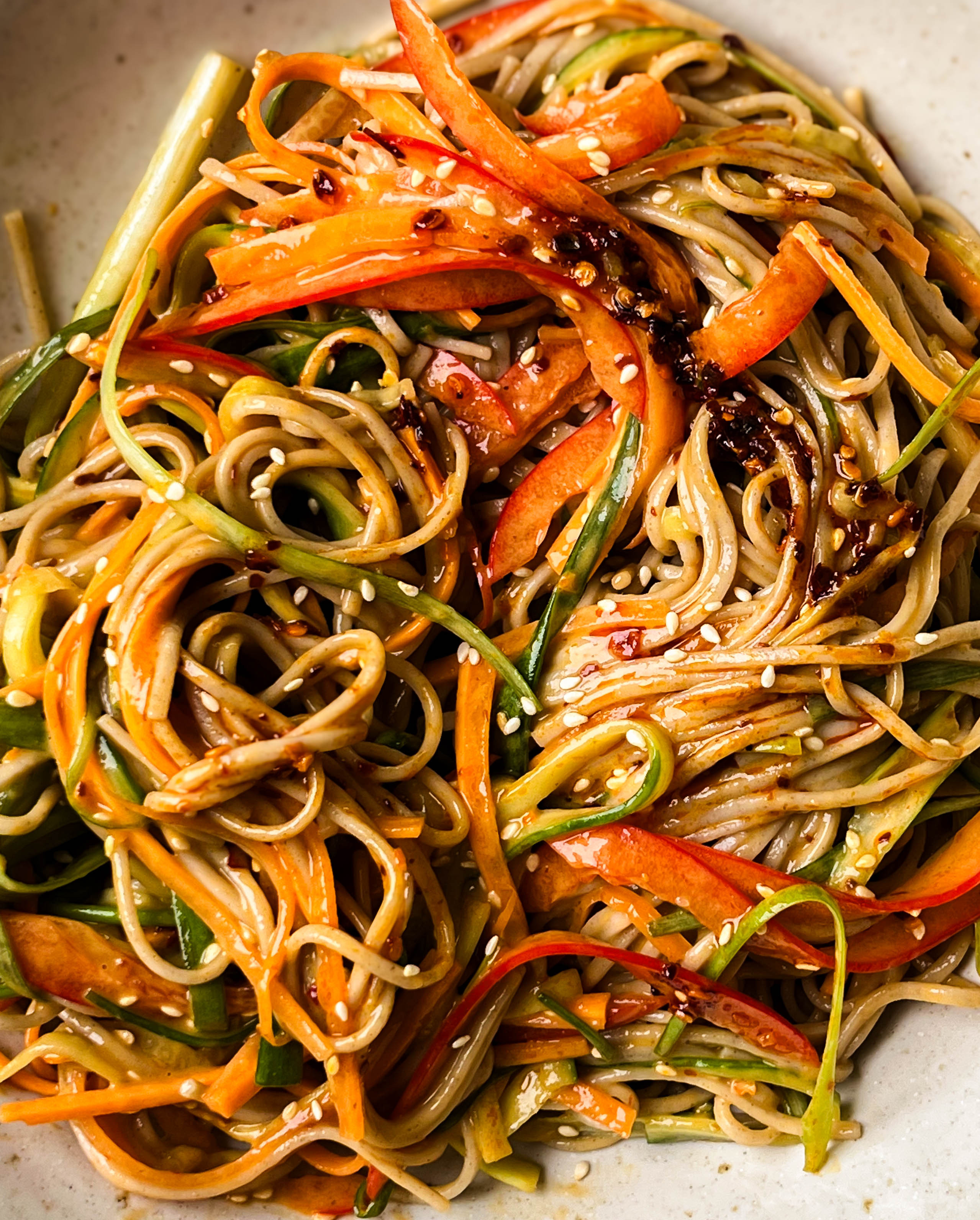 peanut soba noodle salad in a white bowl