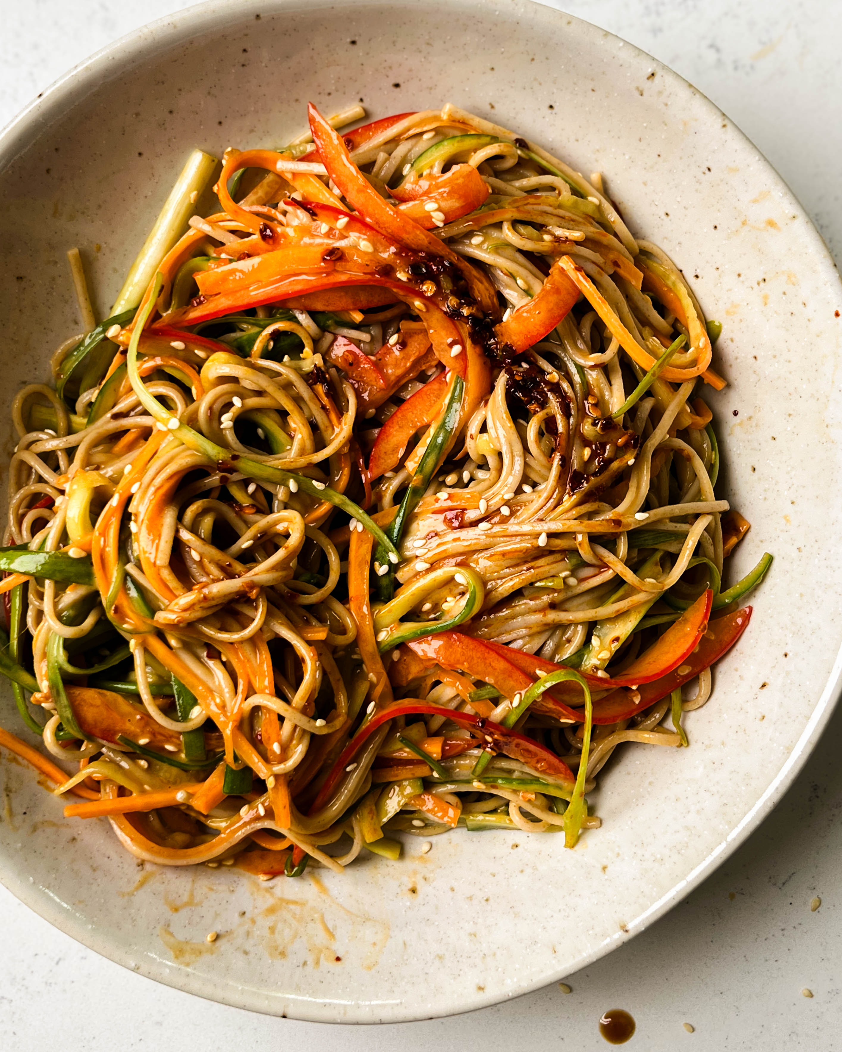 peanut soba noodle salad in a white bowl