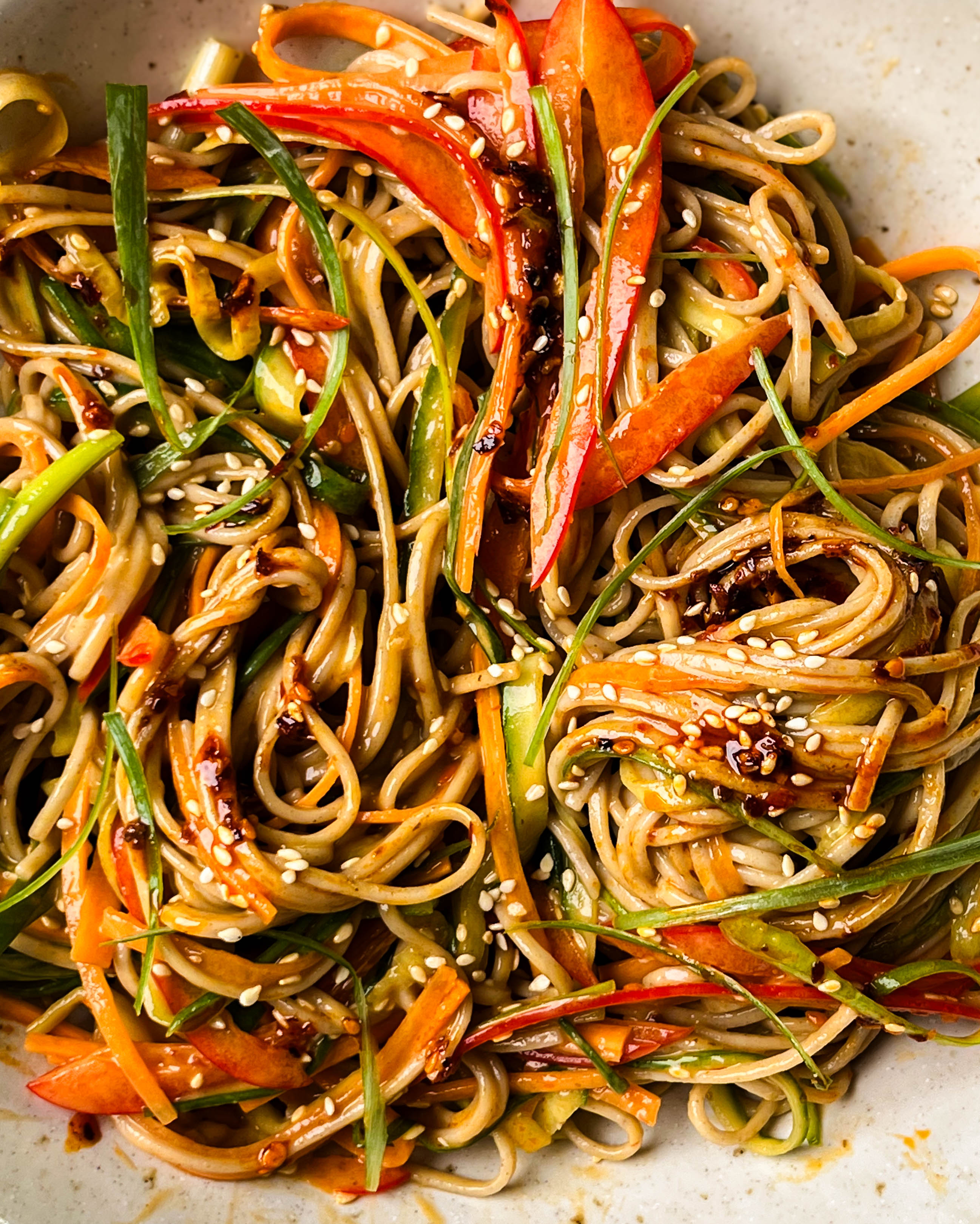 peanut soba noodle salad in a white bowl