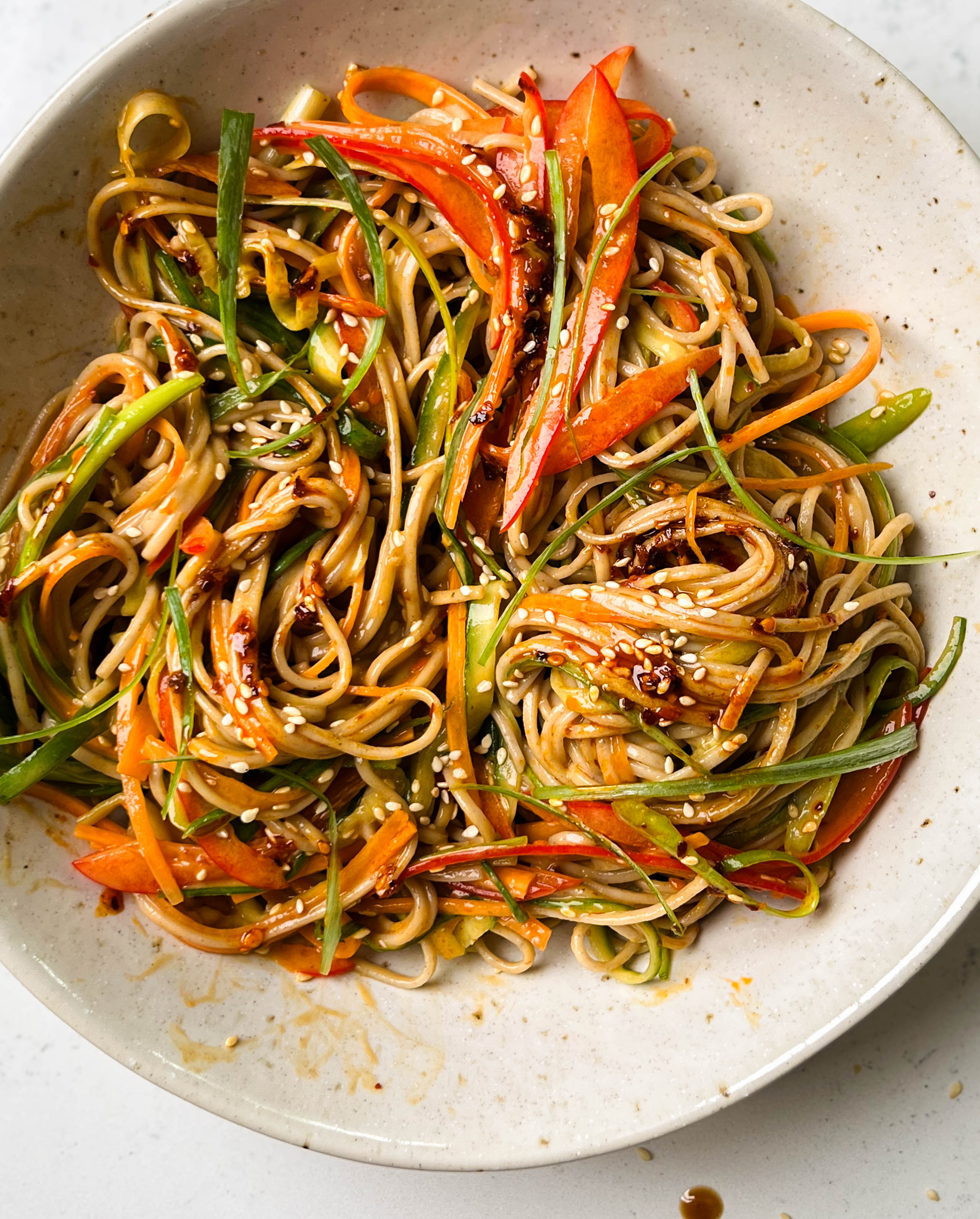 peanut soba noodle salad in a white bowl